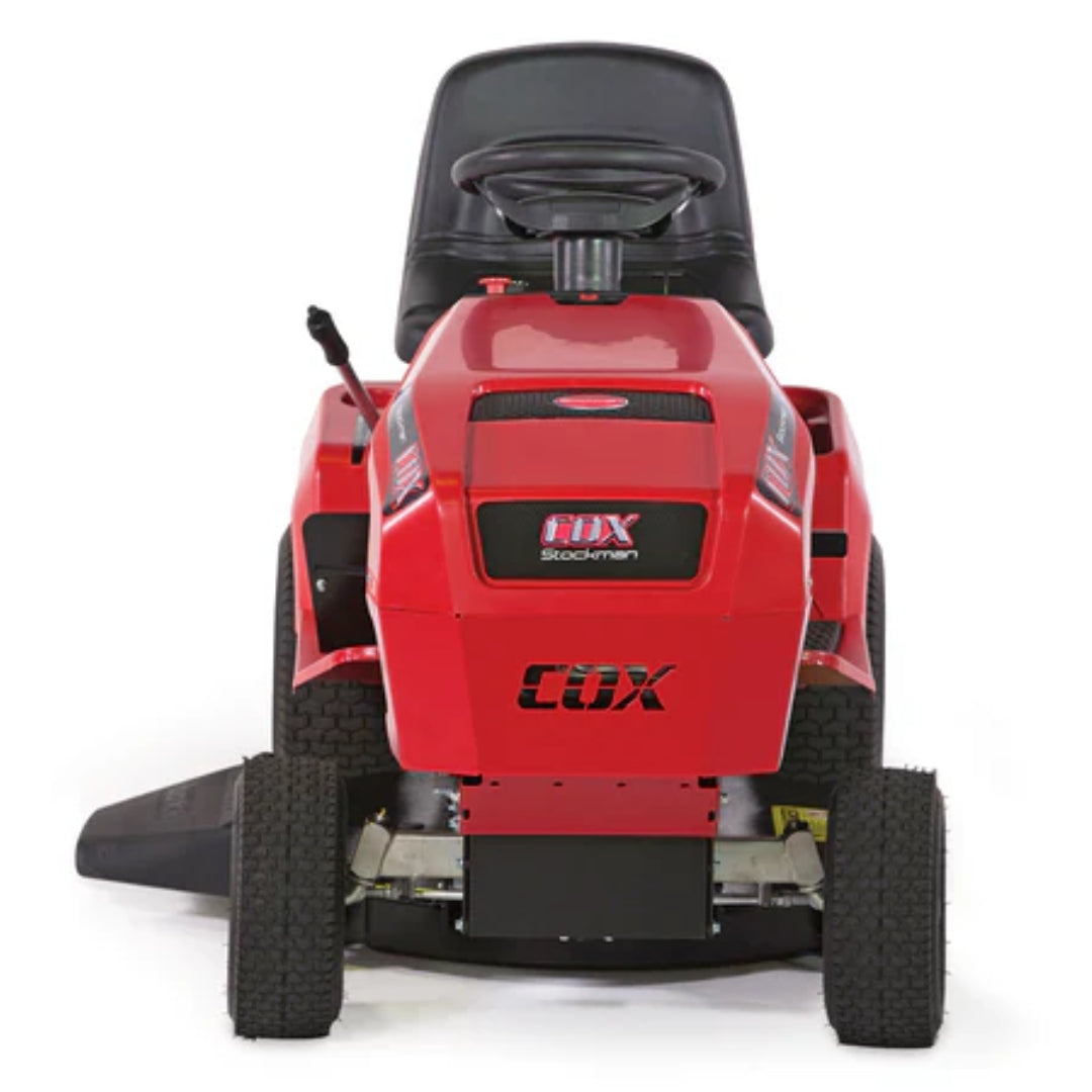 Red Cox Stockman ride on mower seen from the from angle on white background.