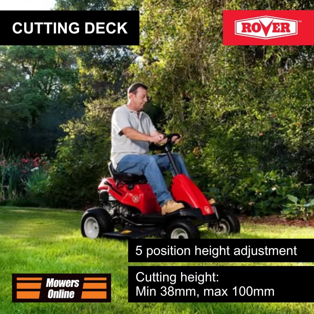 Man operating a red Rover lawn mower on grass with trees in the background