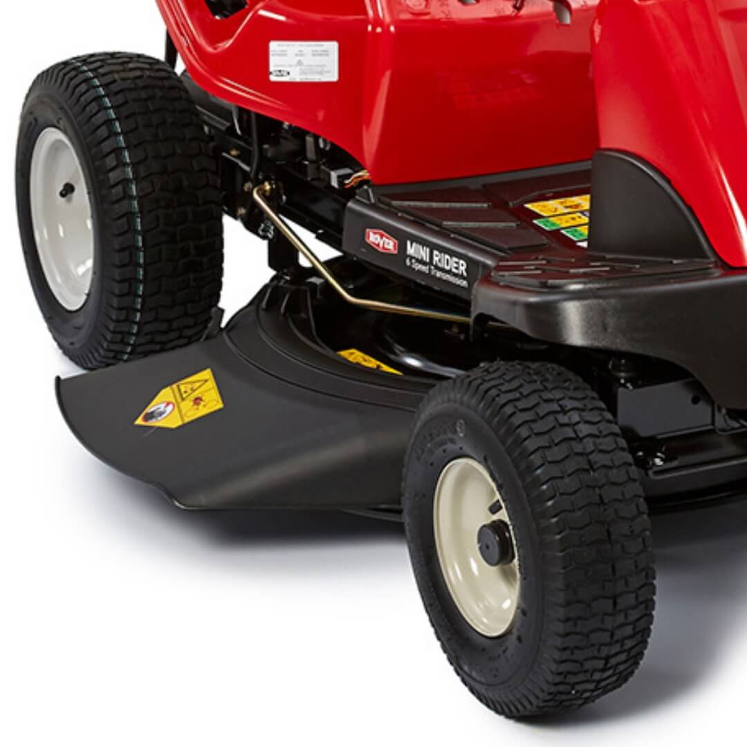 Close-up of a red lawn mower with black deck and tires on a white background