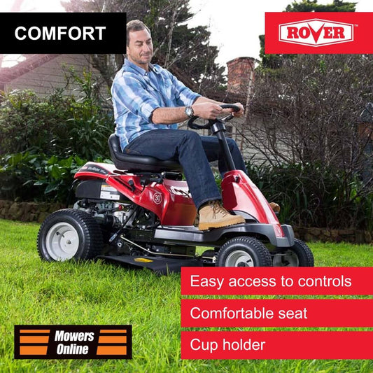 Man operating a red riding lawn mower with Rover branding, surrounded by greenery.