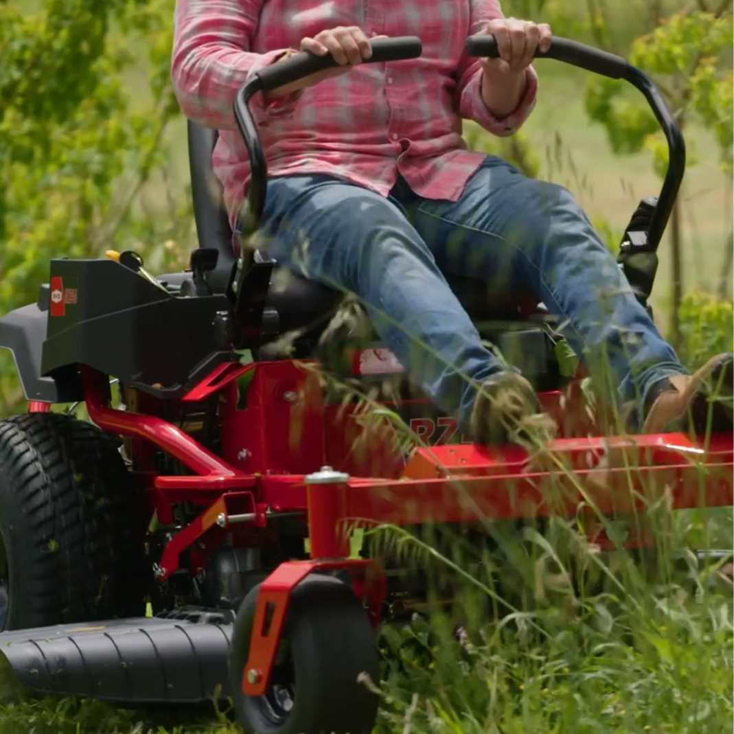 Load video: Man riding the Rover RZ ride on mower through long grass